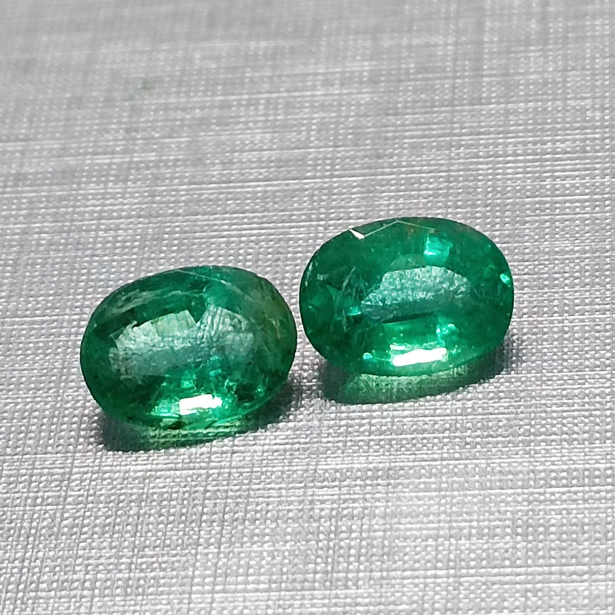 3.55ct vivid green oval mix cut emerald pair